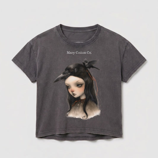 Dark gray t-shirt with a girl wearing a bird mask and Mary Cotton Co. logo.