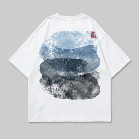 White t-shirt with abstract blue, grey, and red brush strokes on the back.
