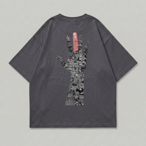 Dark grey t-shirt with a graphic of a traffic jam within a hand silhouette.