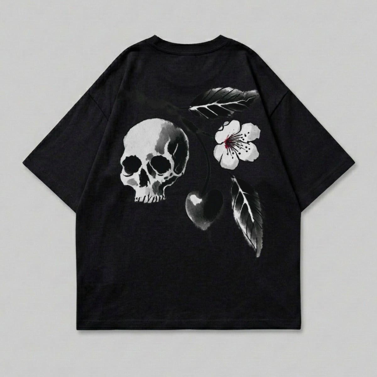 Black t-shirt with a skull, heart, flower, and leaf design.