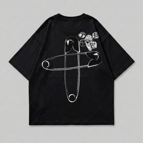 Black t-shirt with large safety pin and patches graphic on the back.