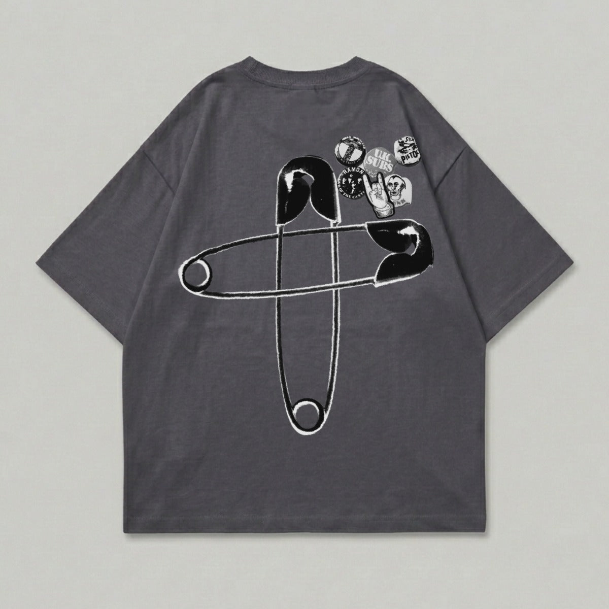 Dark gray t-shirt with large safety pin graphic and band patches.