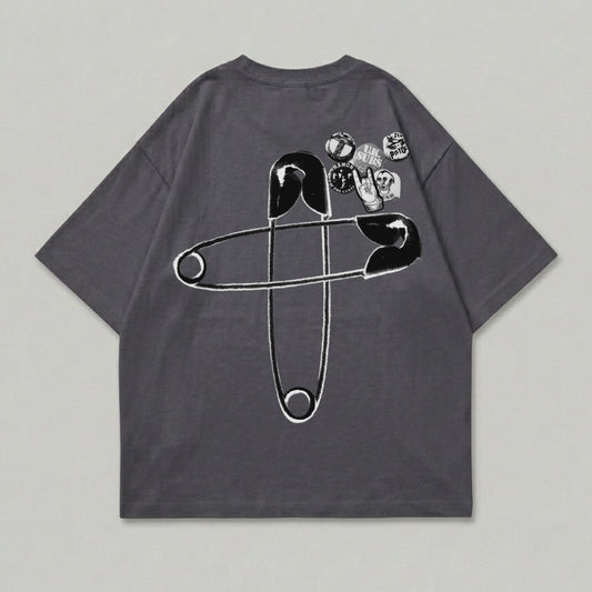 Dark gray t-shirt with large safety pin graphic and band patches.