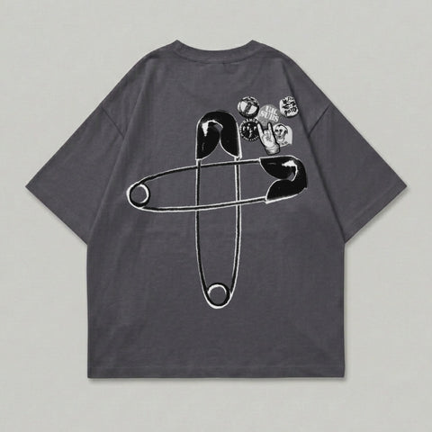 Dark gray t-shirt with large safety pin graphic and band patches.