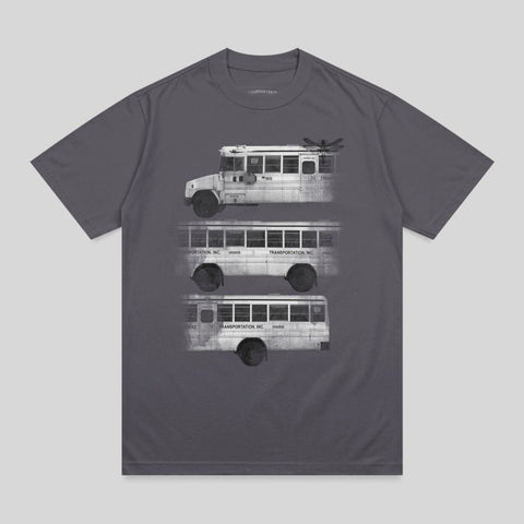 Three school buses in a stacked, grayscale illustration on a charcoal t-shirt.