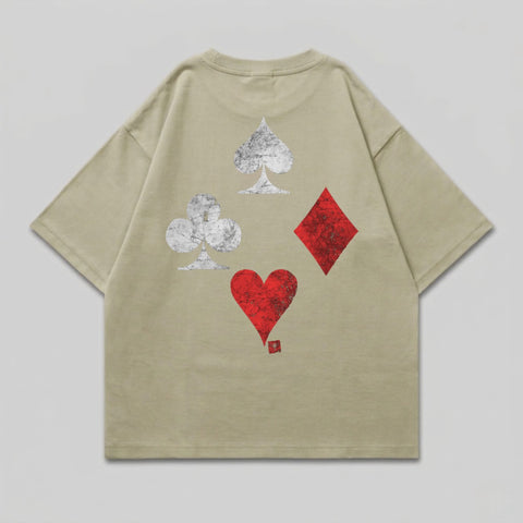 Tan t-shirt with distressed spade, club, diamond, and heart suit symbols on back.