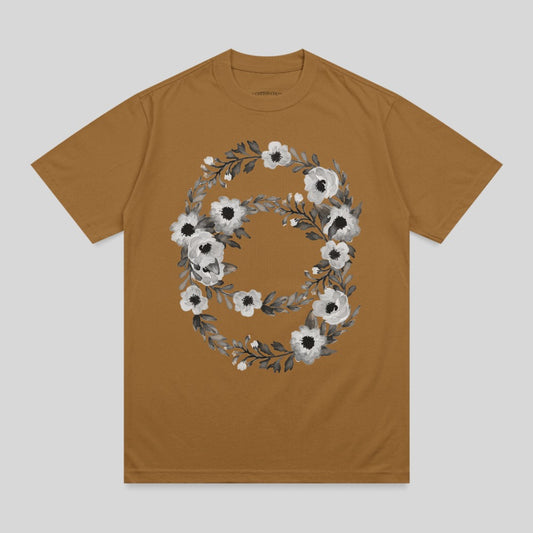 Brown t-shirt with a circular floral design in black and white.