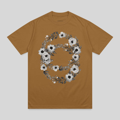 Brown t-shirt with a circular floral design in black and white.