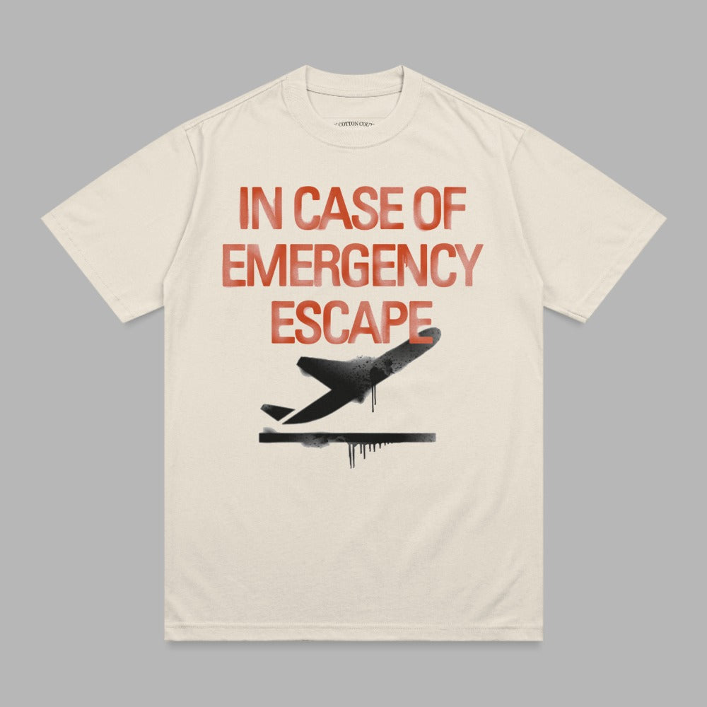 Cream t-shirt with "IN CASE OF EMERGENCY ESCAPE" text and a black airplane graphic.