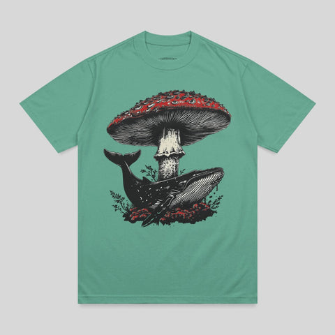 Whale and mushroom illustration on a teal t-shirt.