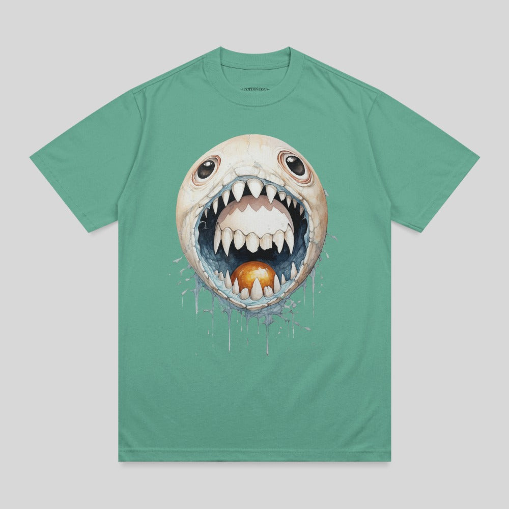 Green t-shirt with a cartoon monster face with sharp teeth and a golden egg.