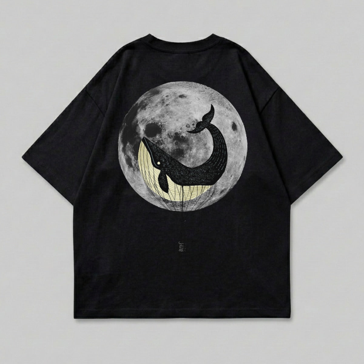 Black t-shirt with a whale in a hot air balloon against a full moon.