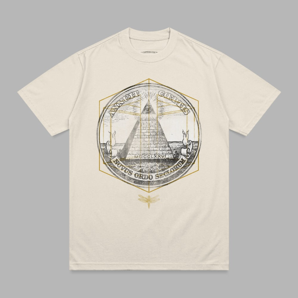 Cream t-shirt with an all-seeing eye pyramid emblem and "Novus Ordo Seclorum" text.