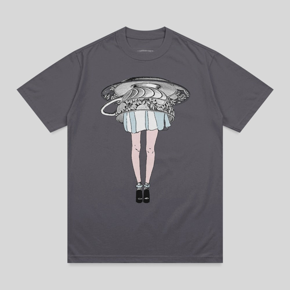 T-shirt with a woman's legs and skirt emerging from an overturned teacup.