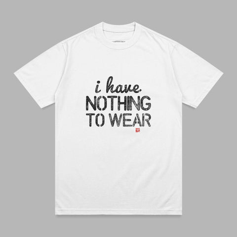White t-shirt with black text "i have. NOTHING TO WEAR." and a small red stamp.