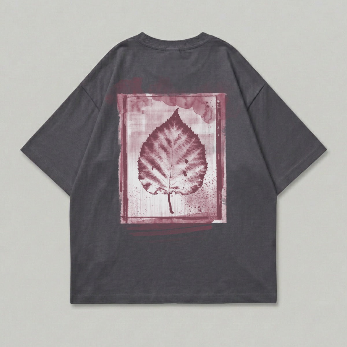 Dark grey t-shirt with a maroon leaf print in a painted frame.