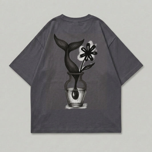 Gray t-shirt with a vase holding a flower and a whale tail.