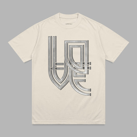Cream t-shirt with a silver geometric "WE" logo design.