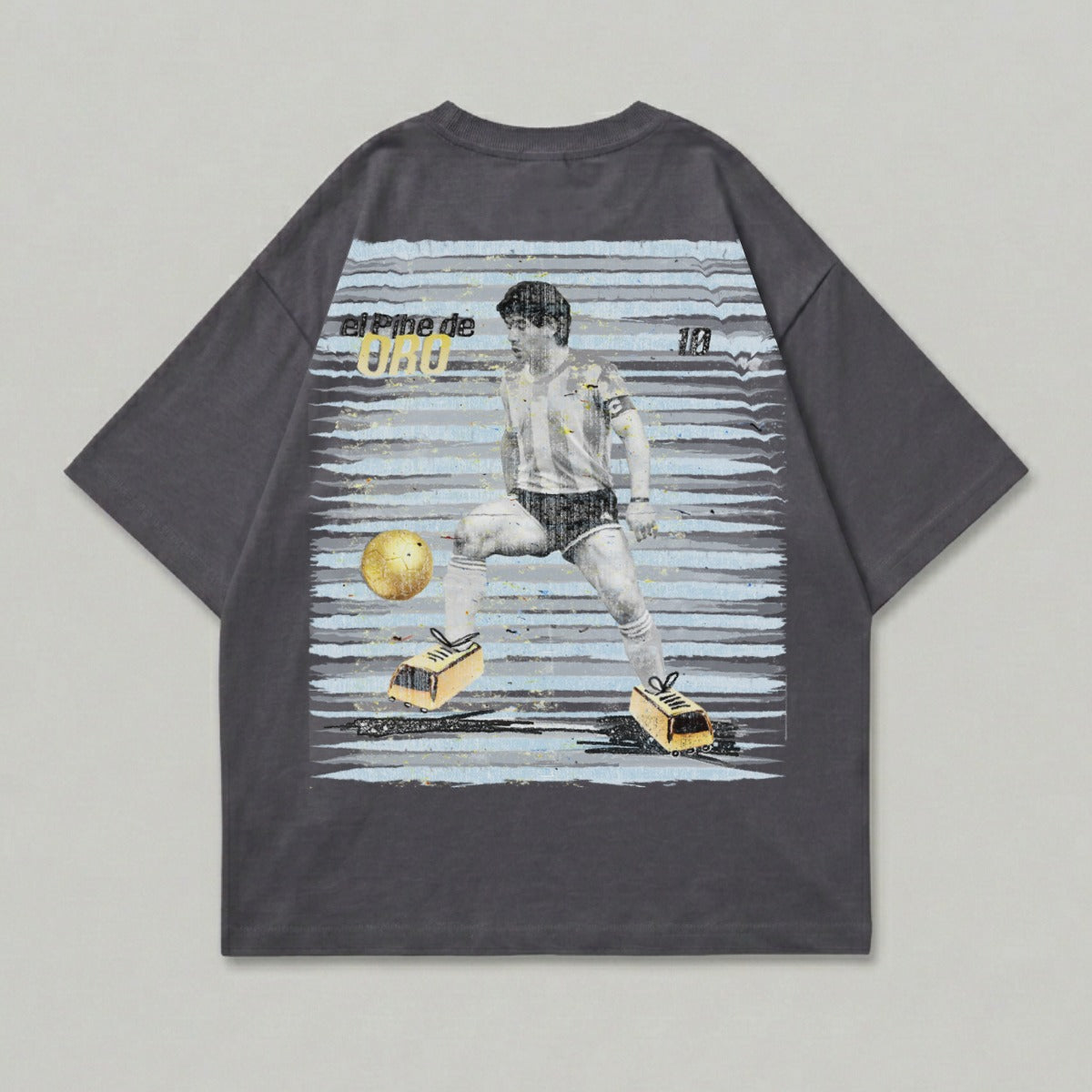 T-shirt with graphic of Diego Maradona kicking a soccer ball and "El Pibe de Oro" text.