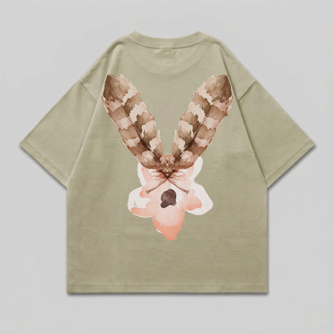 Tan t-shirt with a watercolor-style feather and flower design on the back.