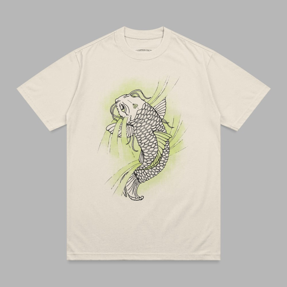 Cream t-shirt with black outline of a koi fish and green abstract shapes.