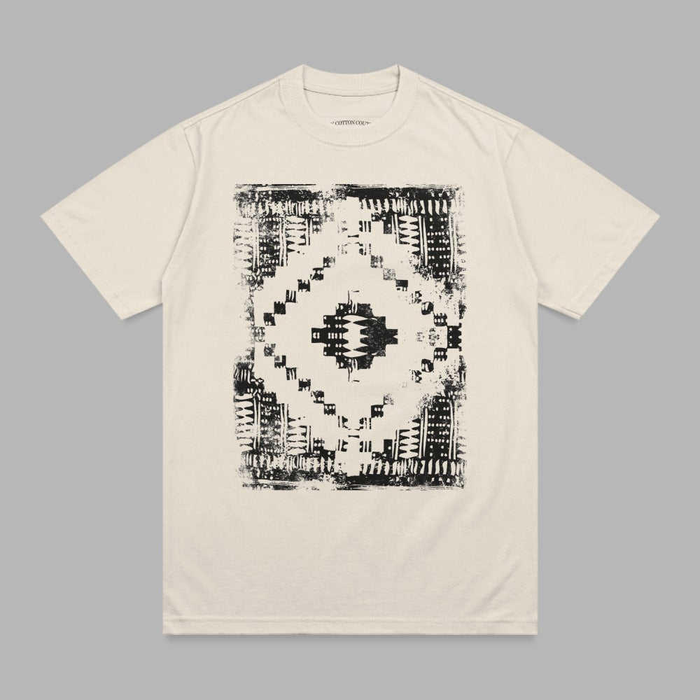 Cream t-shirt with black distressed geometric diamond graphic.