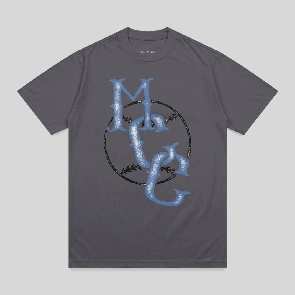 Grey t-shirt with blue "MC" logo and baseball stitching.