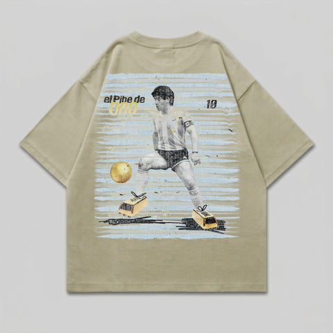 T-shirt graphic of Diego Maradona in action, with text "el Pibe de Oro" and number 10.