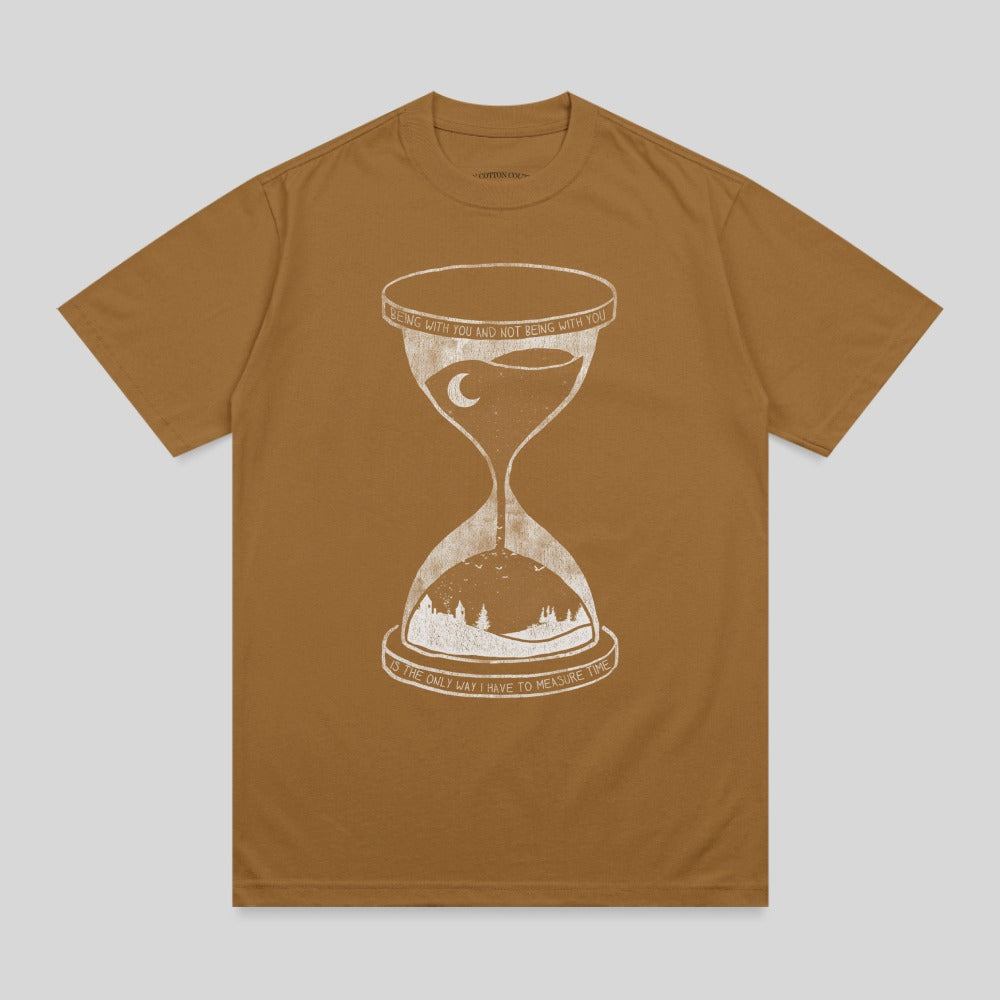 Brown t-shirt with hourglass and landscape graphic and text.