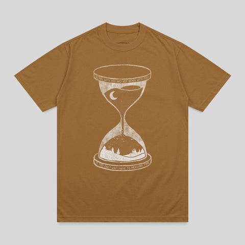 Brown t-shirt with hourglass and landscape graphic and text.