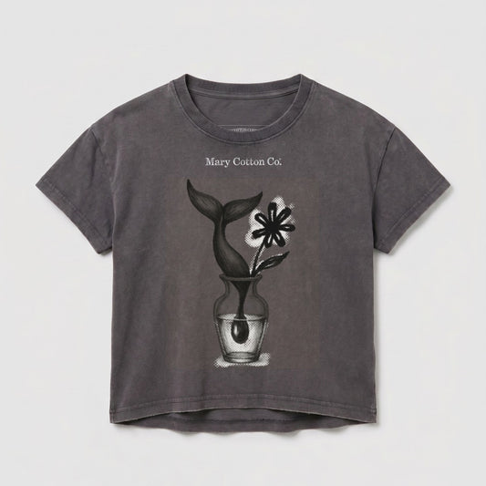 T-shirt with a vase, flower, and whale tail illustration and "Mary Cotton Co." text.