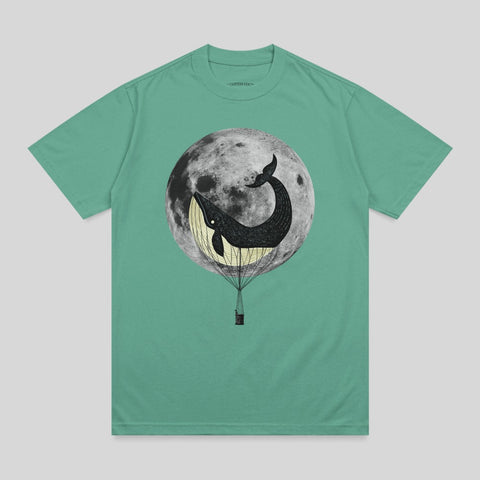 Whale in hot air balloon against a full moon graphic on a t-shirt.