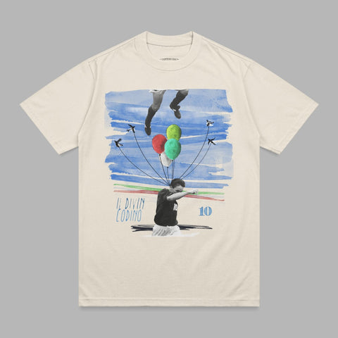 Cream t-shirt featuring a graphic of a soccer player with balloons and the text "IL DIVIN CODINO 10".