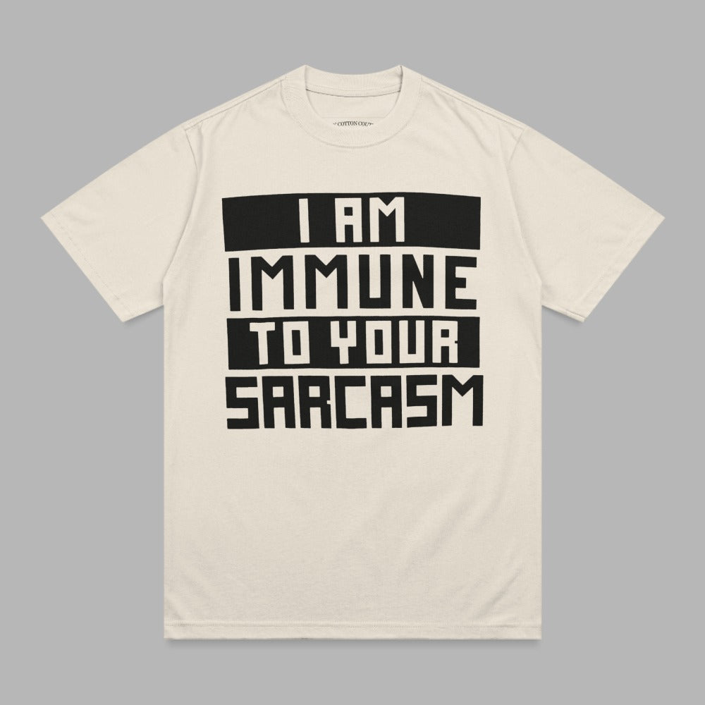 Cream t-shirt with black text reading "I AM IMMUNE TO YOUR SARCASTIC".