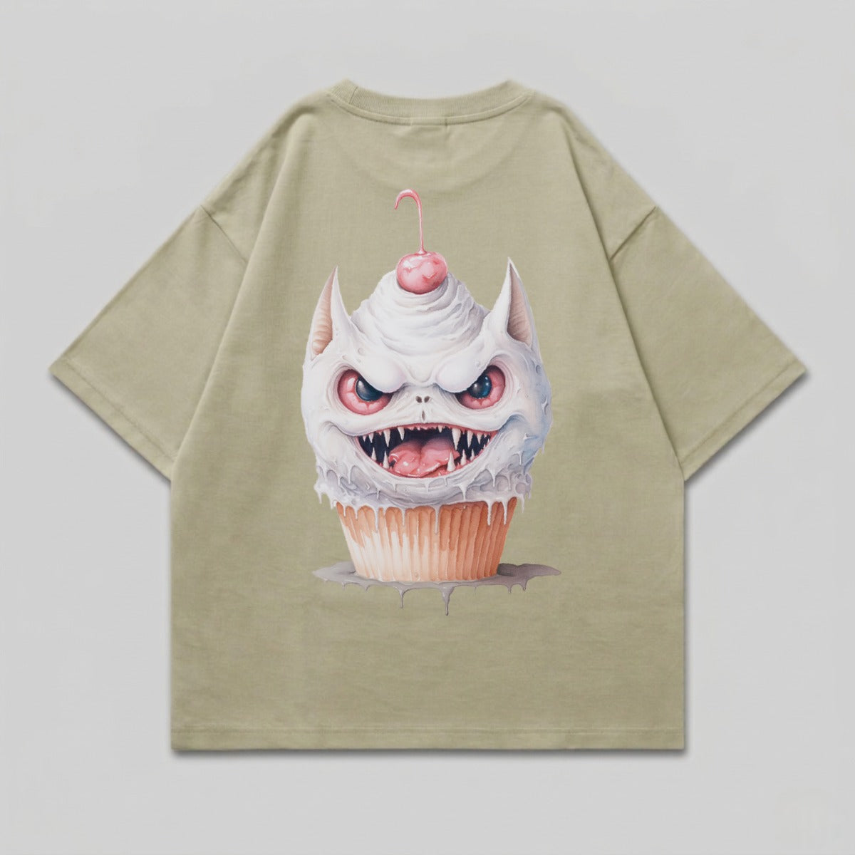 Green t-shirt with a cartoon cupcake monster graphic.