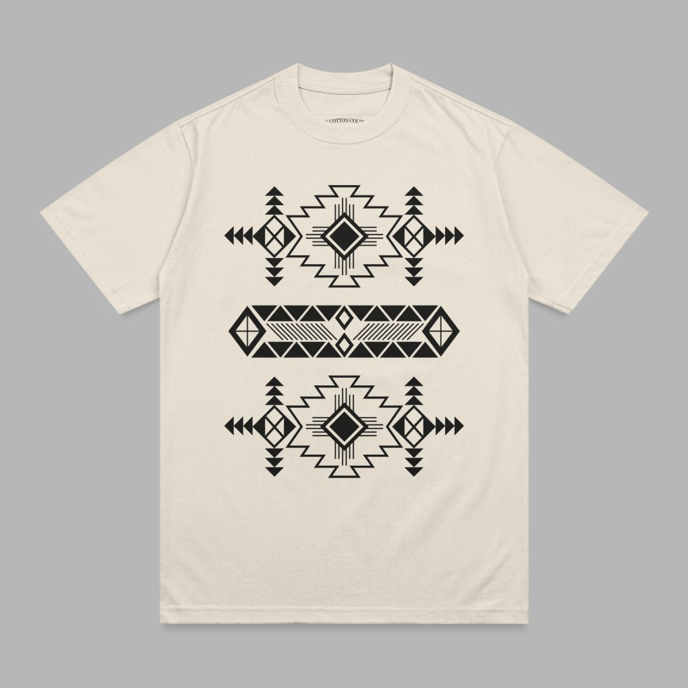 Cream t-shirt with black geometric tribal pattern across chest.