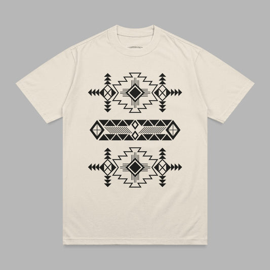 Cream t-shirt with black geometric tribal pattern across chest.