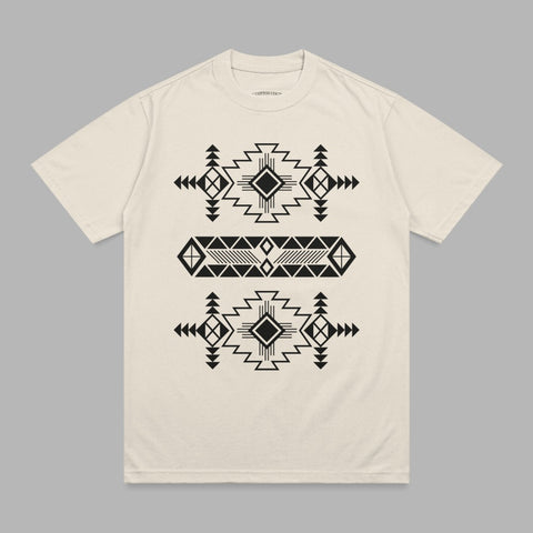 Cream t-shirt with black geometric tribal pattern across chest.