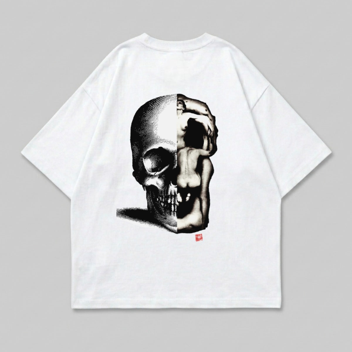 White t-shirt with a black and white graphic of a skull merging with a human figure.