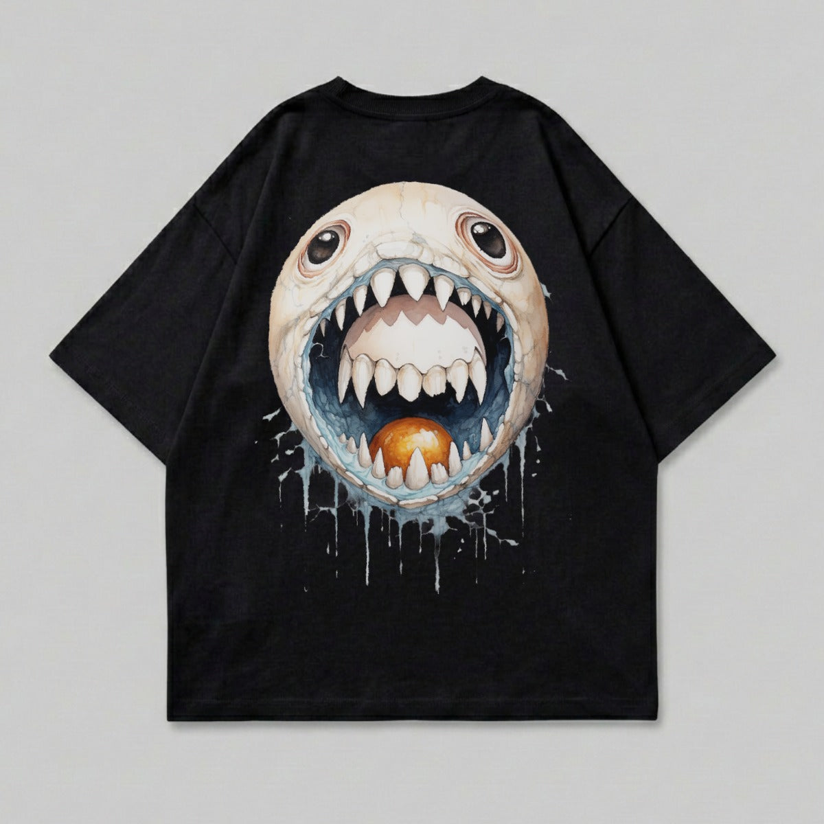 Black t-shirt with a cartoon monster face with sharp teeth and an orange sphere in its mouth.