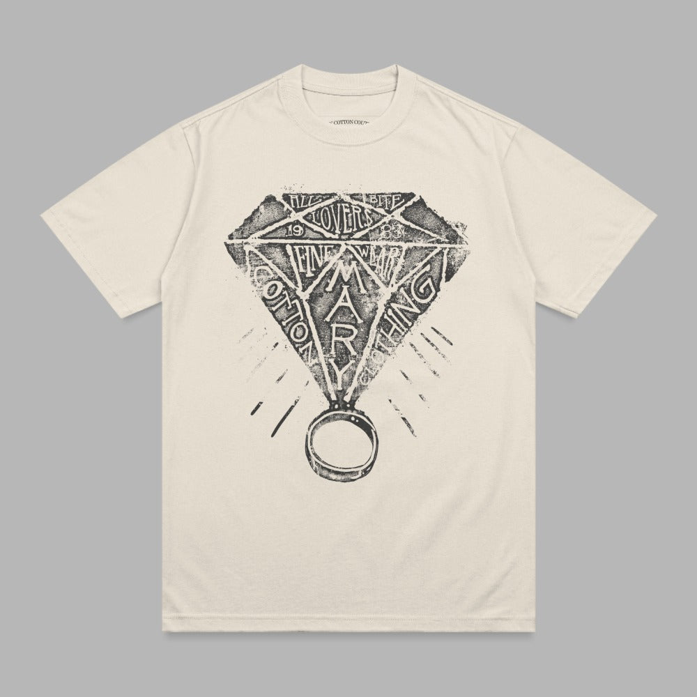 Diamond ring graphic with "Cotton Mary" text on cream t-shirt.