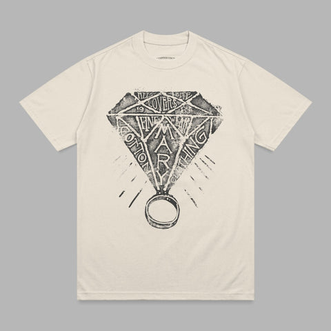 Diamond ring graphic with "Cotton Mary" text on cream t-shirt.
