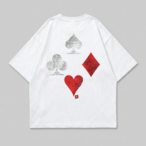 White t-shirt with scattered grey spade, red heart, and red diamond playing card suits.