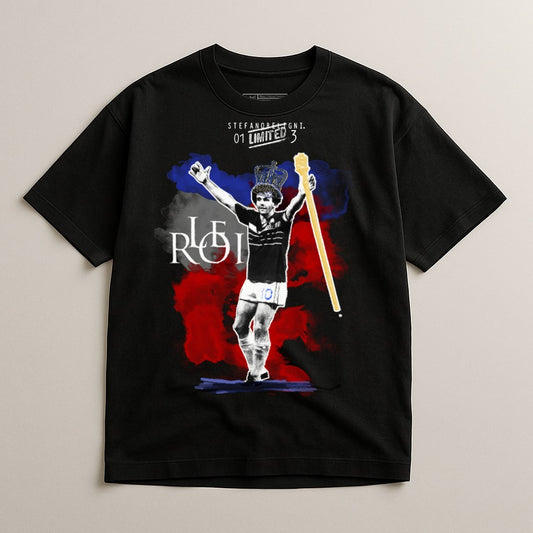 Black t-shirt with artwork of a soccer player in a crown holding a scepter.