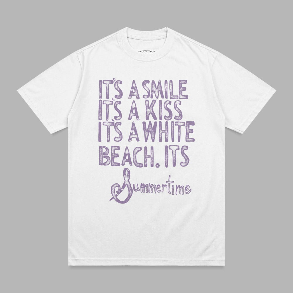 White t-shirt with purple text: "It's a smile, it's a kiss, it's a white beach. It's Summertime."