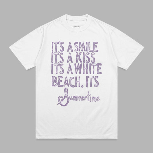 White t-shirt with purple text: "It's a smile, it's a kiss, it's a white beach. It's Summertime."