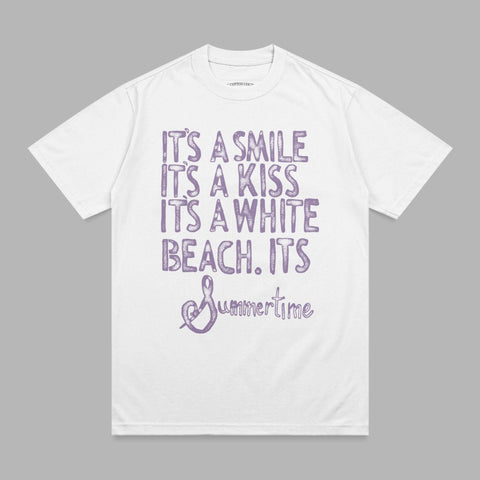 White t-shirt with purple text: "It's a smile, it's a kiss, it's a white beach. It's Summertime."