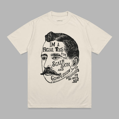Cream t-shirt with man's head graphic and text about facial treatments.