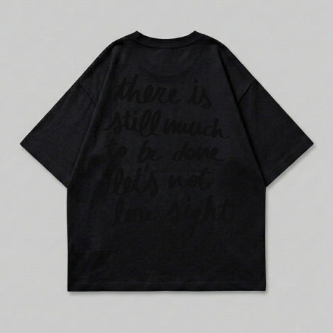 Black t-shirt with dark text reading "there is still much to be done let's not lose sight".