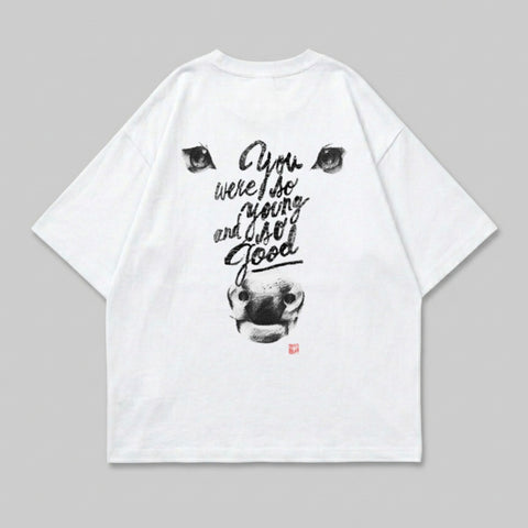 White t-shirt with a black ink drawing of a cow's head and text.